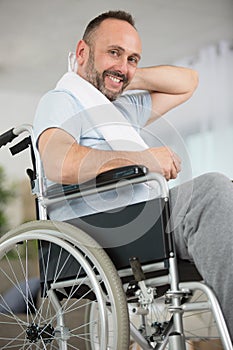 Man in wheelchair towelling off after exercising