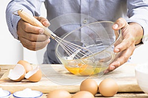 Man whisking egg in his kitchen