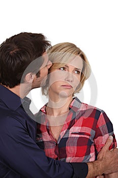 Man whispering in woman's ear