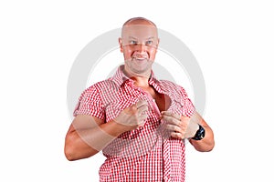 A man on a white background fastens his shirt