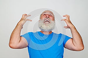 Man with white beard is infuriated and nervous