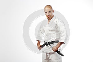 Man in white kimono posing on white background