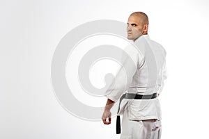 Man in white kimono posing on white background
