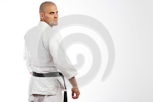 Man in white kimono posing on white background