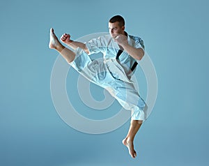Man in white kimono training karate