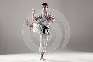 Man in white kimono training karate