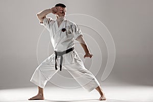 Man in white kimono training karate