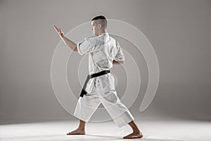 Man in white kimono training karate