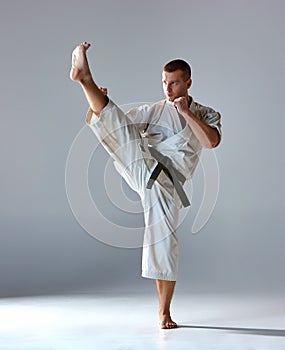 Man in white kimono training karate