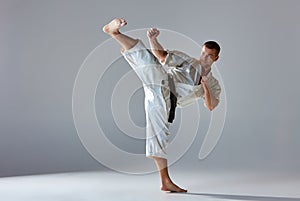Man in white kimono training karate