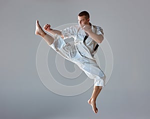 Man in white kimono training karate