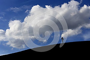 Man at white sand dune in early morning on blue sky, Muine,