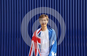 The man in white shirt with Australia flag on his shoulder