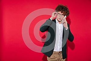 Man in white shirt and jacket talking on mobile phone