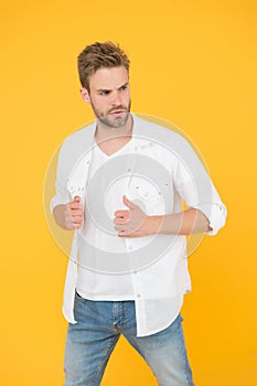 Man in white shirt. Muscular man in jeans yellow background. fashion and people concept. Sexy and handsome. Confident