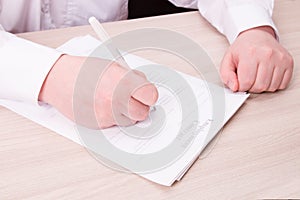 a man in a white shirt presses a finger on a pink service bell and signs a contract, a legal employment contract in the service se