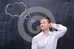 Man in white shirt thinking hard