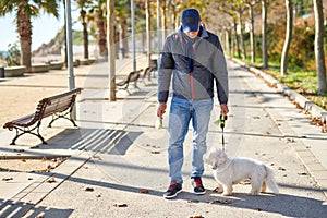 Man white small dog walk park