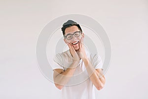 Man in white t-shirt and glasses with big smile isolated on white background. A very kind student has a good mood