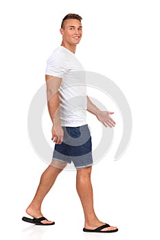 Man In White T-shirt Is Walking And Looking At Camera.