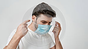 Man in white t-shirt wearing medical mask