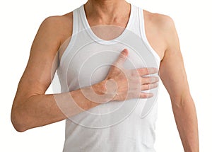 Man in white undershirt with hand on his heart