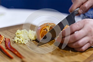 Man who cuts citrus on a wooden hoe