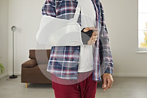 Man who has injured his arm, hand, wrist or elbow is wearing brace and support sling
