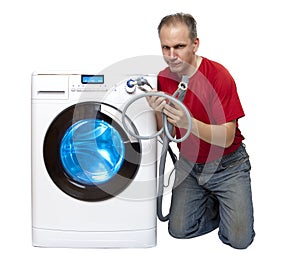 Man who has thought of repair or connection of the washing machine near the new washing machine