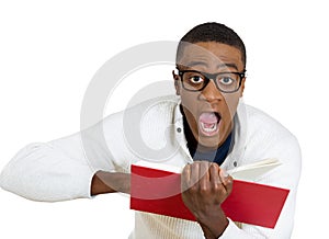 Man wide opened eyes mouth pointing at a page inside book