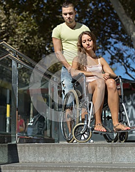 Man and wife in wheelchair on stairs