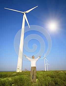 Man and wind turbines under sky