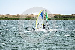 Man windsurfing close to the town of Caernarfon in Wales - United Kingdom