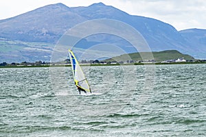 Man windsurfing close to the town of Caernarfon in Wales - United Kingdom