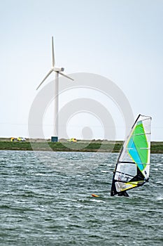 Man windsurfing close to the town of Caernarfon in Wales - United Kingdom