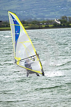 Man windsurfing close to the town of Caernarfon in Wales - United Kingdom