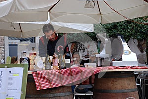 Man at Wine and Ham Stall