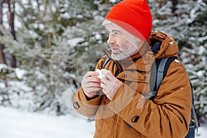 Man in a winter forest looking sick and unwell