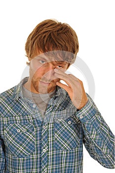 Man wiping tears from eye