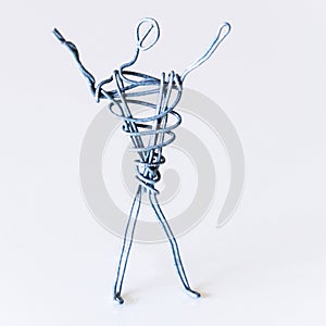 A man of wire is standing, raising his hands up, symbolizing success, joy, dream