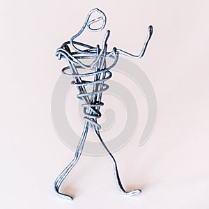 A man of wire stands in a boxing stance, symbolizing the struggle against difficulties, determination, activity