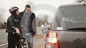 Man And Woman Arguing With Each Other After Car Bicycle Accident
