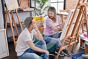 Man and woman artists couple smiling confident drawing at art studio