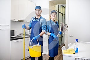 Man and woman as a professional cleaners indoors