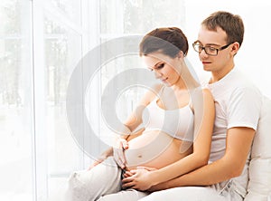 Man and woman awaiting a baby. Family at home