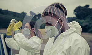 Man and woman with bacteriological protection equipment