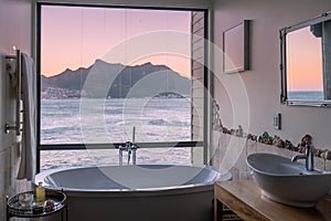 man and woman in bath tub jaccuzi on vacation, couple man and woman in bath tub looking out over the ocean of Cape Town