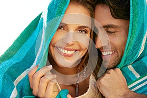 Man, woman and beach or towel for protection or together for weekend, bonding or embrace. Happy couple, portrait and