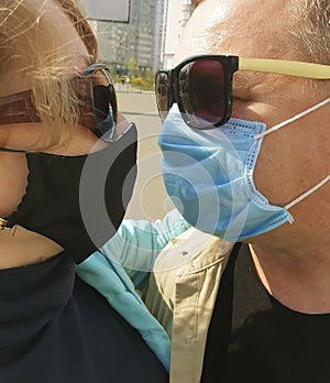 Man and woman beautiful happy pandemic portrait together danger protective lifestyle quarantine mask kiss protection