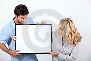 Man and woman with blank board